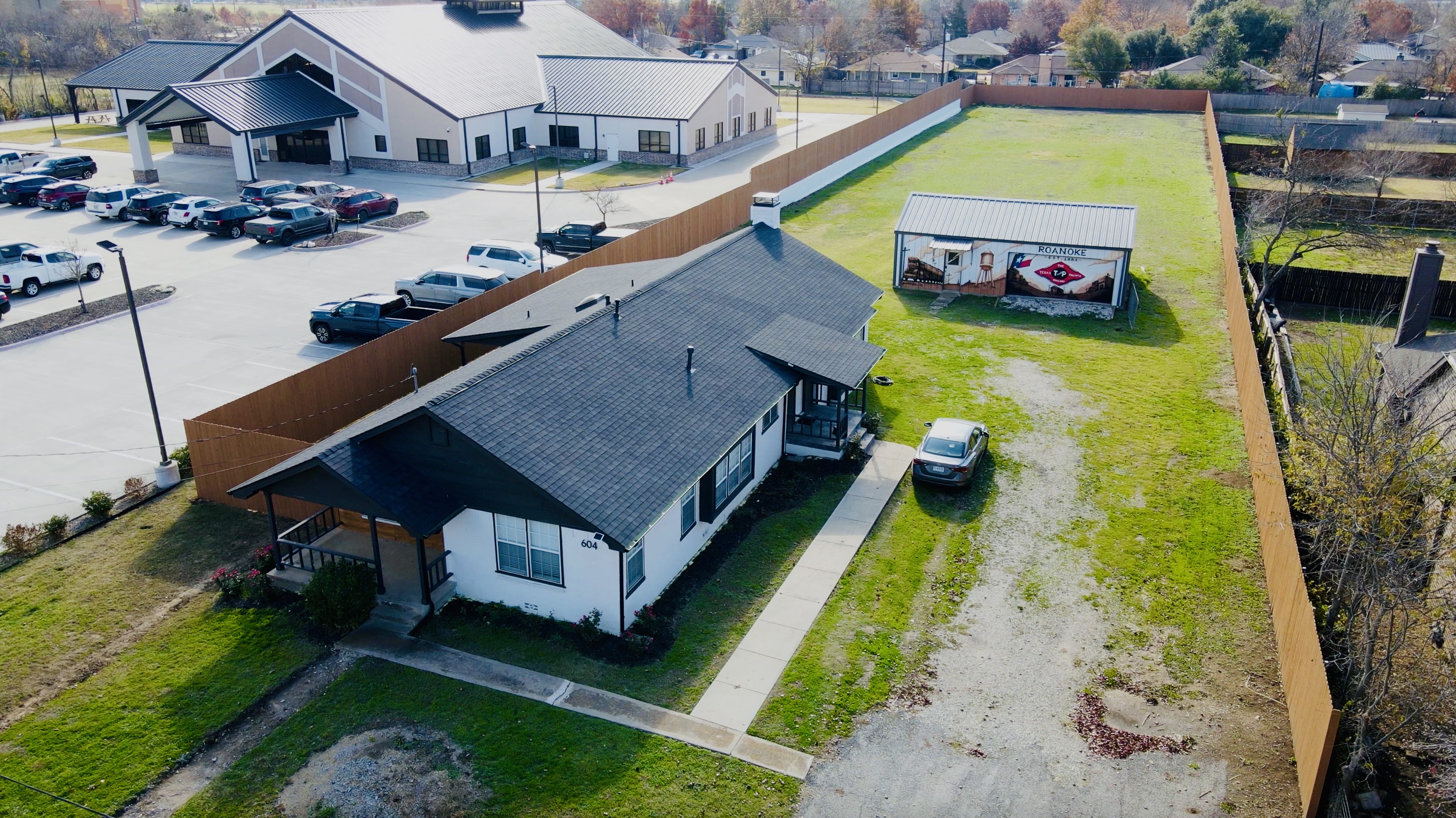 Aerial view across the R&D Yard property and open testing lawn in Roanoke, Texas